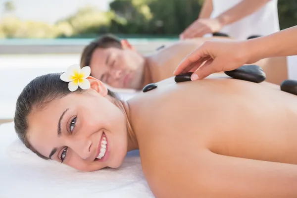 Casal desfrutando de massagem de pedra quente — Fotografia de Stock