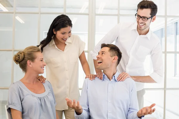 Business team congratulating colleague — Stock Photo, Image