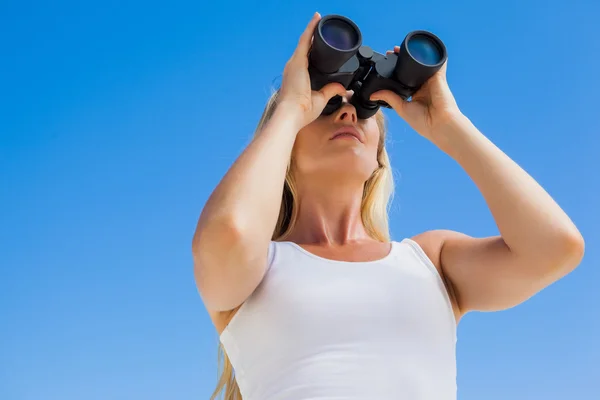 Blonde looking through binoculars — Stock Photo, Image