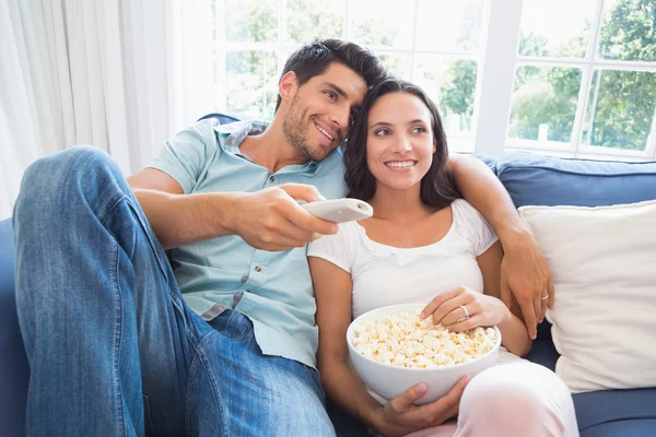 Couple watching tv on the couch Royalty Free Stock Images