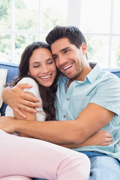 Attractive couple cuddling on the couch — Stock Photo, Image