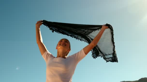 Happy woman holding black scarf — Stock Video