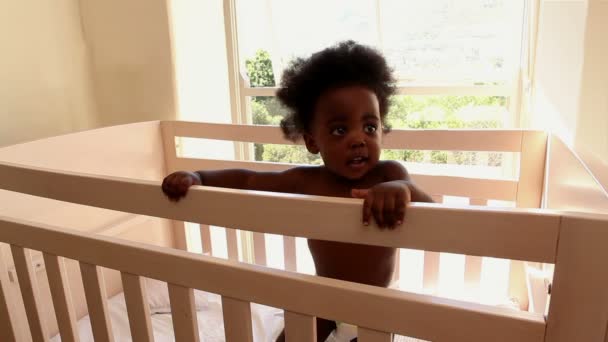 Baby girl in her crib in bedroom — Stock Video