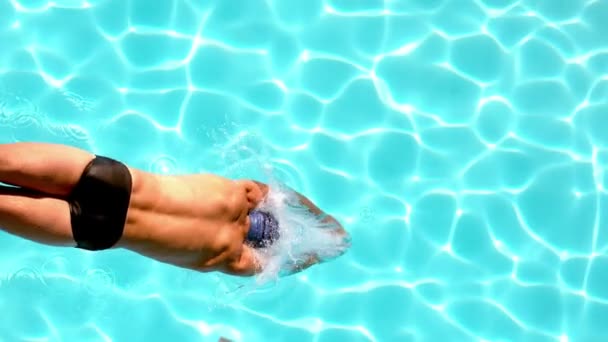 Athletic swimmer diving into the pool — Stock Video