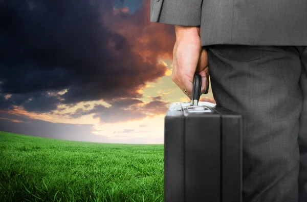 Composite image of businessman holding briefcase — Stock Photo, Image