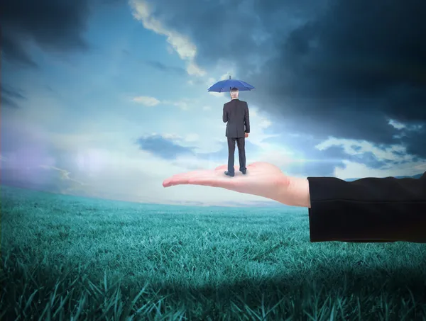 Businessman holding umbrella — Stock Photo, Image