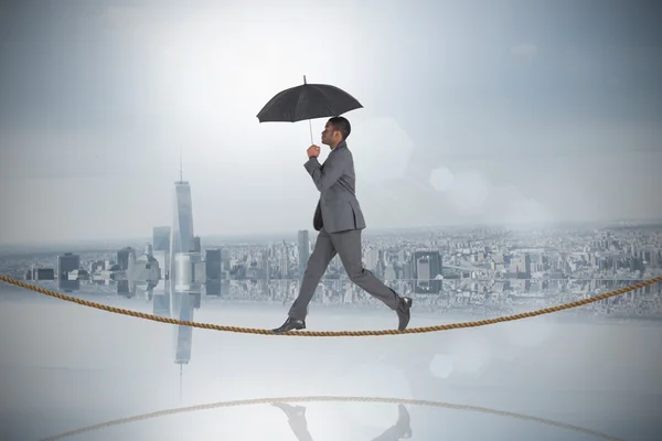 Businessman walking on tightrope — Stock Photo, Image