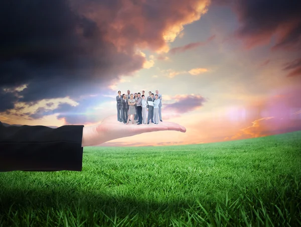 Business team against green field — Stock Photo, Image