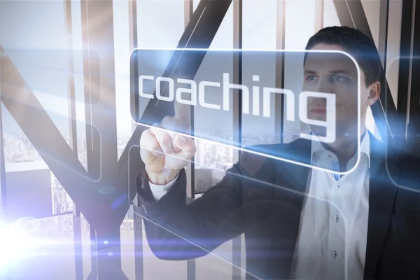 Businessman presenting the word coaching — Stock Photo, Image