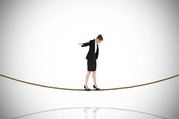 Businesswoman performing balancing act on tightrope — Stock Photo, Image