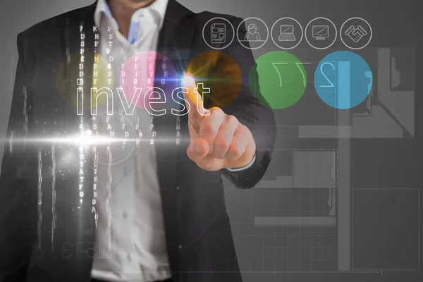 Businessman touching the word invest on interface — Stock Photo, Image