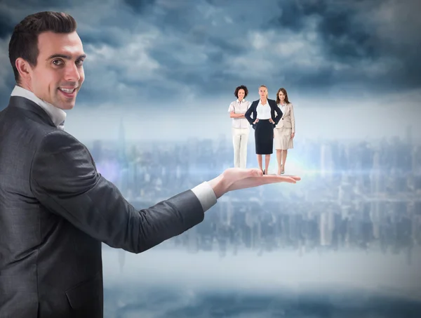 Composite image of businessman holding business team — Stock Photo, Image