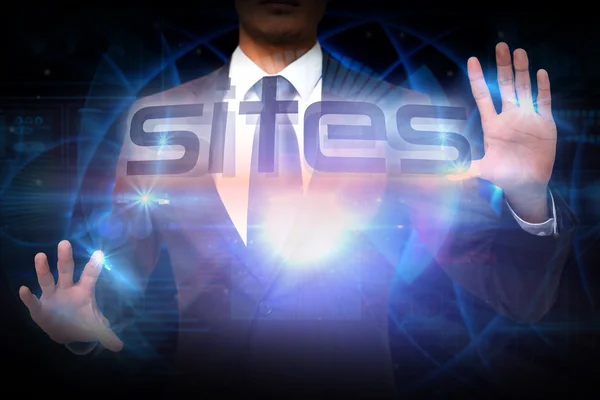 Businessman presenting the word sites — Stock Photo, Image