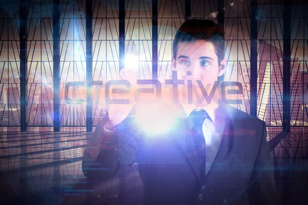 Businessman presenting the word creative — Stock Photo, Image