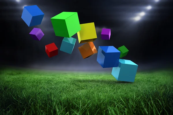 Красочные кубики против футбольного поля — стоковое фото