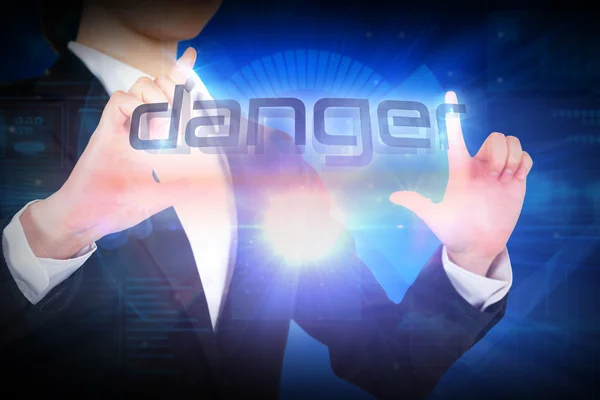 Businesswoman presenting the word danger — Stock Photo, Image