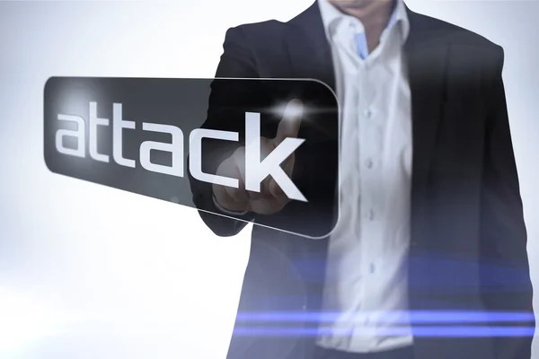 Affärsman som pekar till ordet attack — Stockfoto