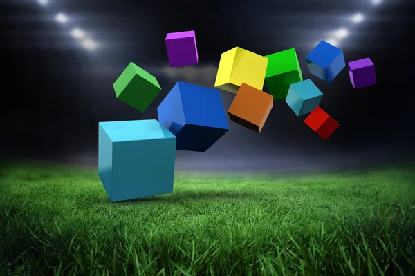 Colourful cubes against football pitch — Stock Photo, Image