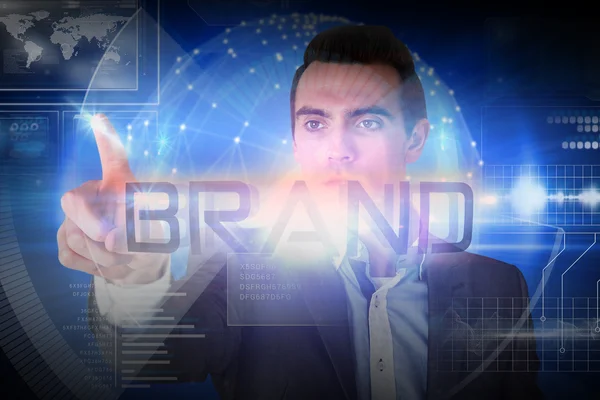 Businessman presenting the word brand — Stock Photo, Image