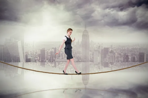 Businesswoman doing balancing act on tightrope — Stock Photo, Image