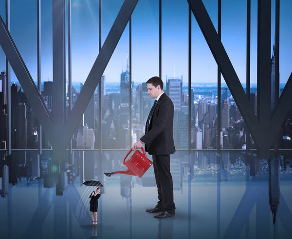 Businessman watering tiny businesswoman — Stock Photo, Image