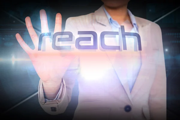 Businesswoman presenting the word reach — Stock Photo, Image