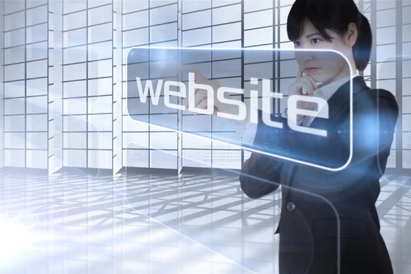 Businesswoman looking at the word website — Stock Photo, Image