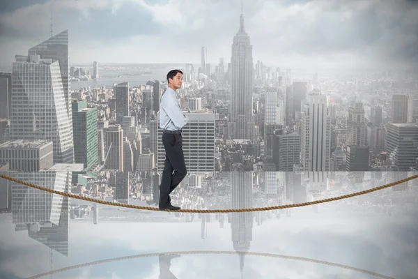 Serious asian businessman  on tightrope — Stock Photo, Image