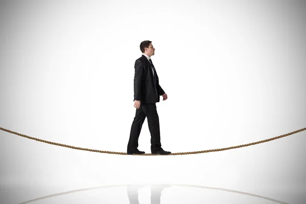 Businessman stepping on tightrope — Stock Photo, Image