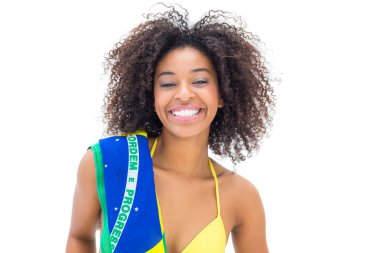 Fit girl in yellow bikini holding brazil flag clipart