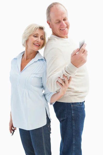 Happy mature couple looking at smartphone together — Stock Photo, Image