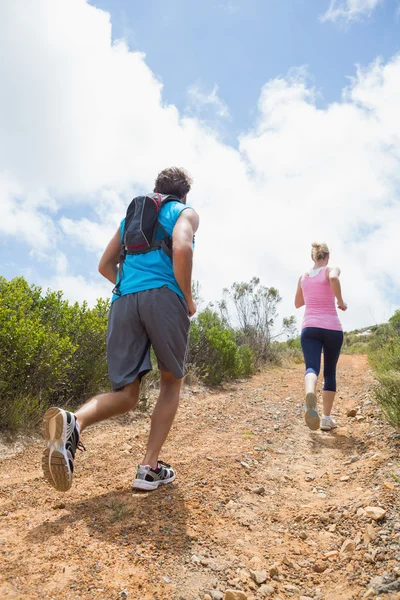Par jogging upp skogsstig — Stockfoto