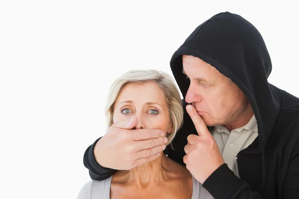 Older man silencing his fearful partner — Stock Photo, Image