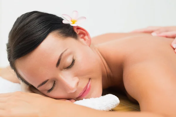 Peaceful brunette enjoying a back massage — Stock Photo, Image