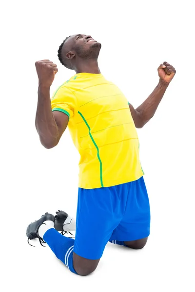 Футболист в желтом празднует победу — стоковое фото