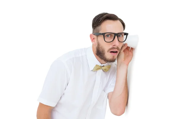 Geeky businessman eavesdropping with cup — Stock Photo, Image
