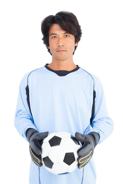 Goalkeeper in blue holding ball — Stock Photo, Image