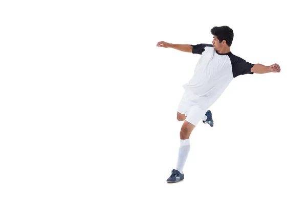 Football player in white kicking — Stock Photo, Image