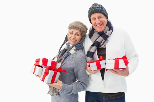 Ώριμο ζευγάρι σε χειμωνιάτικα ρούχα κρατώντας δώρα — Φωτογραφία Αρχείου