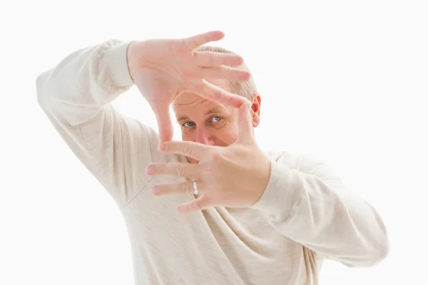 Happy mature man framing with hands — Stock Photo, Image