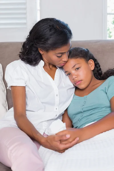 Concerned mother cuddling sick daughter — Stock Photo, Image