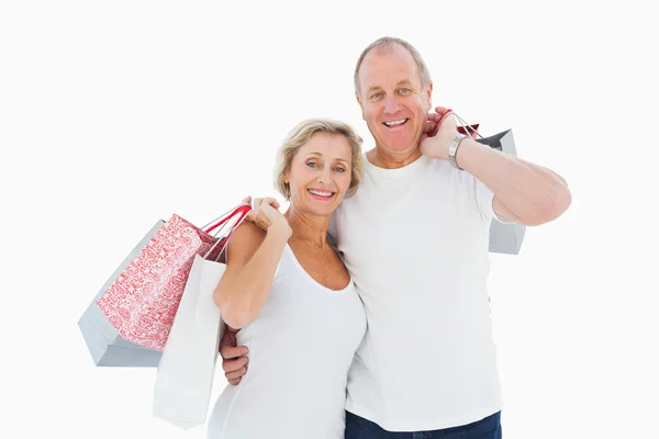 Smiling mature couple holding shopping bags — Stock Photo, Image