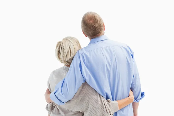 Mature couple hugging and looking — Stock Photo, Image