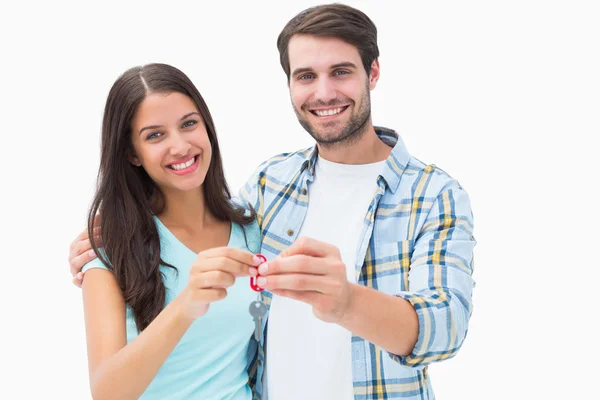 Feliz jovem casal segurando nova chave da casa — Fotografia de Stock