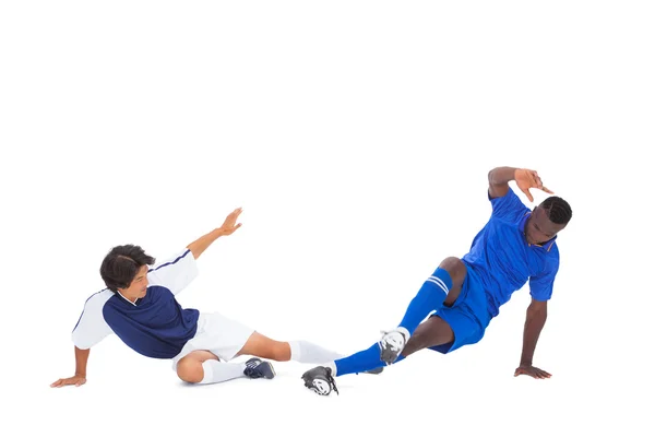 Football players tackling for the ball — Stock Photo, Image