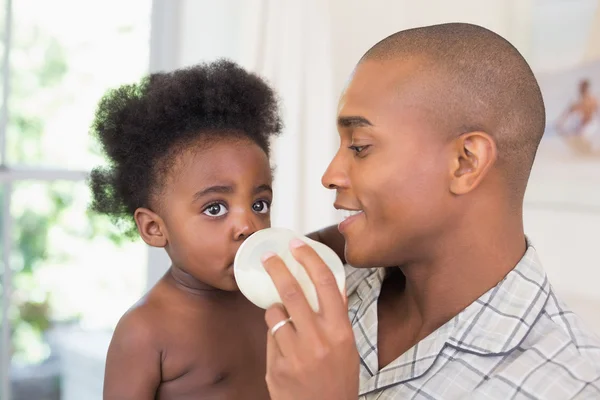 Happy father trying to feeding his baby girl — Stock Photo, Image