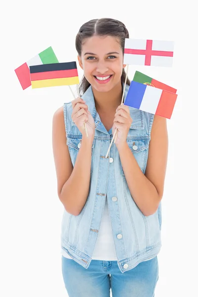 Pretty brunette holding various european flags — Stock Photo, Image