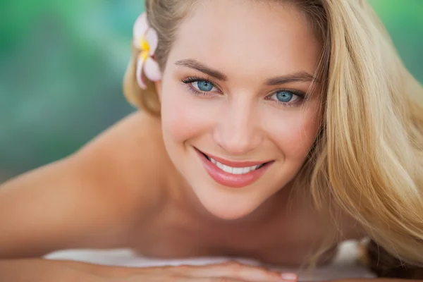 Peaceful blonde lying on towel smiling at camera — Stock Photo, Image