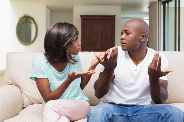 Unhappy couple having an argument on the couch — Stock Photo, Image