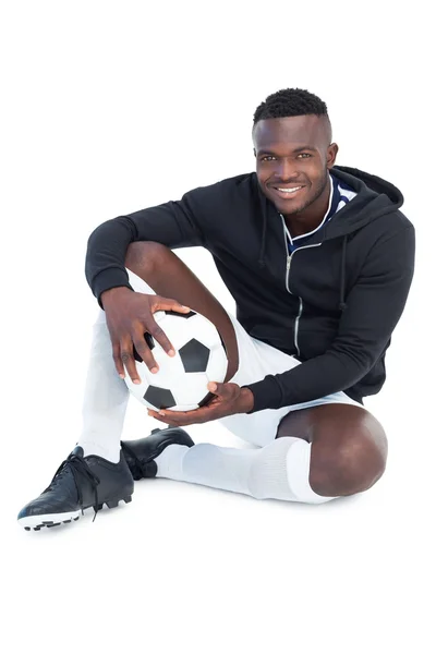 Jogador de futebol sentado com bola — Fotografia de Stock